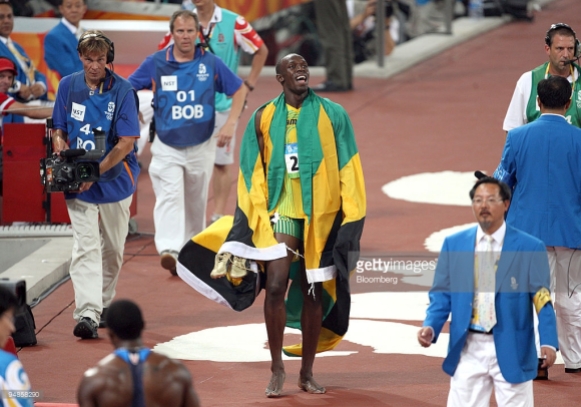 Usain Bolt of Jamaica, smiles as he does a victory lap around Bird's Nest Stadium after winning the gold medal in the men's 200-meter final on day 12 of the 2008 Beijing Olympics in Beijing, China, on Wednesday, Aug. 20, 2008. The 2008 Beijing Olympics will run until Aug. 24, 2008. Natalie Behring/Bloomberg News